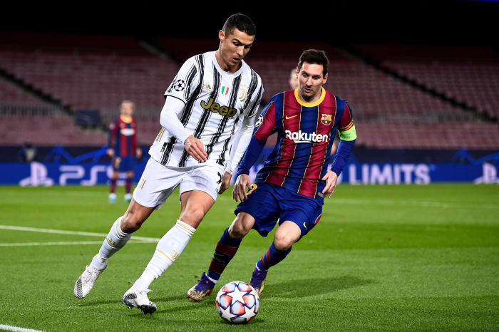 Cristiano Ronaldo (left) and Lionel Messi pictured in action during a UEFA Champions League game between Barcelona and Juventus in December 2020